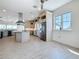 Spacious kitchen boasts stainless appliances, granite counters, a large center island, and wood-look tile flooring at 404 Hillsborough St, Palm Harbor, FL 34683