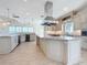 Modern kitchen with an island, custom cabinetry, and stainless steel appliances, designed for style and function at 404 Hillsborough St, Palm Harbor, FL 34683