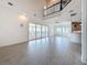 Expansive living area with tile floors, balcony, and water views, connected to the adjacent kitchen area at 404 Hillsborough St, Palm Harbor, FL 34683