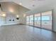 Bright living room with fireplace, hardwood floors, and sliding glass doors leading to a waterfront balcony at 404 Hillsborough St, Palm Harbor, FL 34683