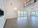 Bright open-concept living room with water view and fireplace, featuring a balcony overlooking the space at 404 Hillsborough St, Palm Harbor, FL 34683