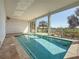 Relaxing covered pool area with tiled flooring and views of lush greenery at 404 Hillsborough St, Palm Harbor, FL 34683