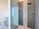 Modern tiled shower featuring glass enclosure and unique stone accents at 404 Hillsborough St, Palm Harbor, FL 34683