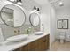 Modern bathroom with dual sinks, round mirrors, and stylish fixtures at 409 E Oak Ave # 9, Tampa, FL 33602