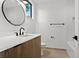 Well-lit bathroom features modern fixtures and a large round mirror at 409 E Oak Ave # 9, Tampa, FL 33602