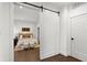 Comfortable bedroom showcasing a well-made bed with cozy decor, complemented by two ottomans and light streaming in at 409 E Oak Ave # 9, Tampa, FL 33602