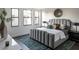 Modern bedroom featuring a large bed with a padded headboard, stylish decor, and plush area rug at 409 E Oak Ave # 9, Tampa, FL 33602
