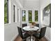 Modern dining room with a round table and bright windows at 409 E Oak Ave # 9, Tampa, FL 33602