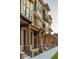 Beautiful exterior view of brick homes with wooden accents, private porches, and well-maintained landscaping at 409 E Oak Ave # 9, Tampa, FL 33602