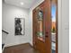 Welcoming foyer with a beautiful wood door, modern art, and stylish flooring that leads to the staircase at 409 E Oak Ave # 9, Tampa, FL 33602