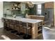 Modern kitchen featuring a breakfast bar with seating, ample cabinets, designer lighting, and stainless steel appliances at 409 E Oak Ave # 9, Tampa, FL 33602