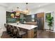 Modern kitchen with a large island, stainless steel appliances, decorative lighting, and stylish backsplash at 409 E Oak Ave # 9, Tampa, FL 33602