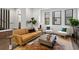 Bright living room featuring a comfortable sofa, modern decor, and hardwood floors at 409 E Oak Ave # 9, Tampa, FL 33602