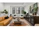 Stylish living room with large windows, modern furniture, and decorative plants at 409 E Oak Ave # 9, Tampa, FL 33602