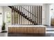 Modern staircase with wooden accents and storage, combining functionality with sleek design at 409 E Oak Ave # 9, Tampa, FL 33602