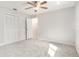 Bedroom features carpeted floors, closet space, a ceiling fan, and neutral paint at 4120 Marine Pkwy, New Port Richey, FL 34652