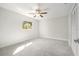 Bright bedroom with carpeted floors, closet, ceiling fan and large window at 4120 Marine Pkwy, New Port Richey, FL 34652