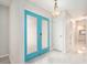 Bright foyer featuring double doors, neutral walls, tiled floors, and modern light fixture at 4120 Marine Pkwy, New Port Richey, FL 34652