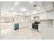 Bright kitchen featuring white cabinets, stainless steel appliances, tiled floors, and modern light fixture at 4120 Marine Pkwy, New Port Richey, FL 34652