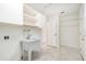 Functional laundry room features a utility sink, storage cabinets, and ample counter space at 4120 Marine Pkwy, New Port Richey, FL 34652