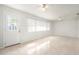 Bright living room with tile floors, ceiling fans and a large window offers ample natural light at 4120 Marine Pkwy, New Port Richey, FL 34652