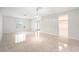 Bright living room featuring neutral walls, tiled floors, and views into the kitchen at 4120 Marine Pkwy, New Port Richey, FL 34652