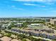 Wide aerial shot offering a glimpse of the community, featuring lush surroundings, a pool, and scenic bay views in the distance at 501 Knights Run Ave # 5101, Tampa, FL 33602