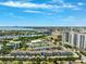 Located near the bay, this aerial pinpoints the community surrounded by tennis courts and mature greenery with clear blue skies at 501 Knights Run Ave # 5101, Tampa, FL 33602