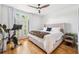 Bright bedroom with a ceiling fan, a large bed, and French doors leading to a balcony at 501 Knights Run Ave # 5101, Tampa, FL 33602