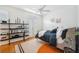 Bedroom featuring hardwood floors, built-in shelving, and a cozy bed with natural light at 501 Knights Run Ave # 5101, Tampa, FL 33602