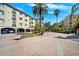 Courtyard view of the complex with fountain, mature trees, covered parking and multiple residences at 501 Knights Run Ave # 5101, Tampa, FL 33602