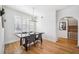 Bright dining room with wood floors, modern chandelier, and natural light from shuttered windows at 501 Knights Run Ave # 5101, Tampa, FL 33602