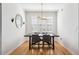 Bright dining room with wood floors, modern chandelier, and natural light from shuttered windows at 501 Knights Run Ave # 5101, Tampa, FL 33602