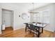 Bright dining room with wood floors, modern chandelier, and natural light from shuttered windows at 501 Knights Run Ave # 5101, Tampa, FL 33602