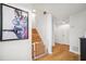 Bright entryway with hardwood floors, white walls, wooden staircase, and modern art at 501 Knights Run Ave # 5101, Tampa, FL 33602