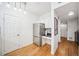 Hallway leading to the kitchen area, featuring hardwood floors and white walls at 501 Knights Run Ave # 5101, Tampa, FL 33602