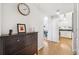 Hallway leading to the kitchen, showcasing a chest of drawers and a clock at 501 Knights Run Ave # 5101, Tampa, FL 33602