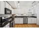 Well-lit kitchen showcasing stainless-steel appliances, black counters, and white cabinetry at 501 Knights Run Ave # 5101, Tampa, FL 33602