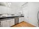 Compact kitchen featuring white cabinets, modern appliances, and a geometric backsplash at 501 Knights Run Ave # 5101, Tampa, FL 33602