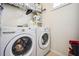 Functional laundry room features modern washer and dryer units and ample storage shelving at 501 Knights Run Ave # 5101, Tampa, FL 33602