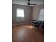 Bedroom with hardwood floors, a ceiling fan, and a small desk for a simple setup at 5220 72Nd N St, St Petersburg, FL 33709
