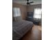 Bedroom with hardwood floors, a ceiling fan, a comfortable bed, and a flat screen TV at 5220 72Nd N St, St Petersburg, FL 33709