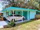 Exterior view of the home featuring a covered parking area and well-manicured lawn at 5220 72Nd N St, St Petersburg, FL 33709