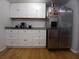 Well-lit kitchen featuring stainless steel refrigerator and ample storage with white cabinets and drawers at 5220 72Nd N St, St Petersburg, FL 33709