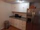 Bright kitchen with white cabinets, granite countertops, and stainless-steel refrigerator at 5220 72Nd N St, St Petersburg, FL 33709