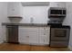 Bright kitchen with stainless steel appliances, granite countertops, and white cabinets offers a modern aesthetic at 5220 72Nd N St, St Petersburg, FL 33709