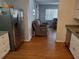 Open kitchen flowing into the living area, featuring stainless steel appliances and hardwood floors at 5220 72Nd N St, St Petersburg, FL 33709
