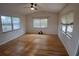 Sun-drenched living room with ceiling fan and three windows showcases the bright, open space at 5220 72Nd N St, St Petersburg, FL 33709
