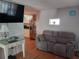 Comfortable living room featuring a plush couch, hardwood floors, and modern décor at 5220 72Nd N St, St Petersburg, FL 33709