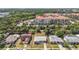 An aerial view showcasing the homes, lush greenery, and the resort buildings in the distance at 6556 S West Shore Cir, Tampa, FL 33616